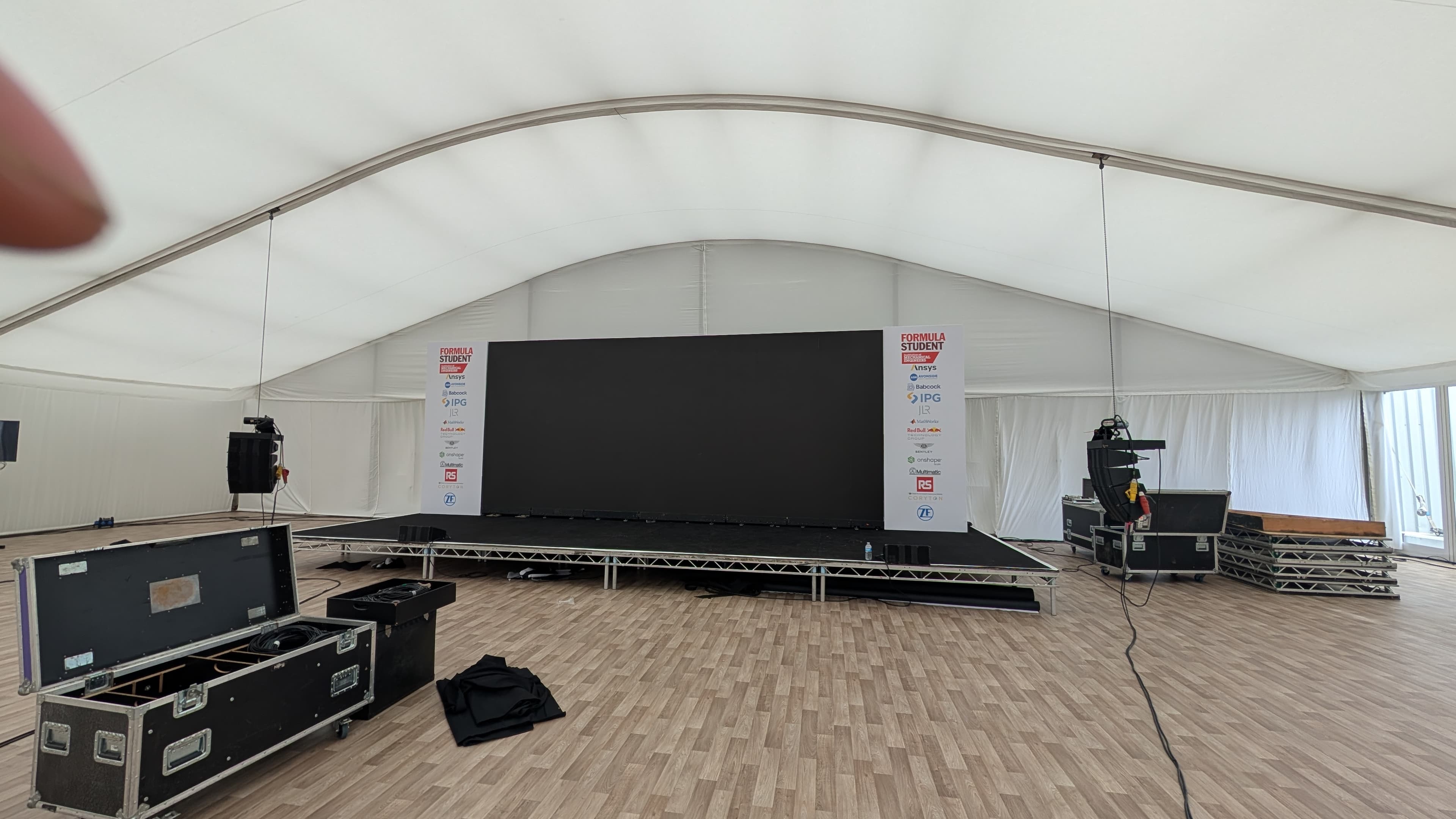 A staged event space with lighting and AV equipment ready for install